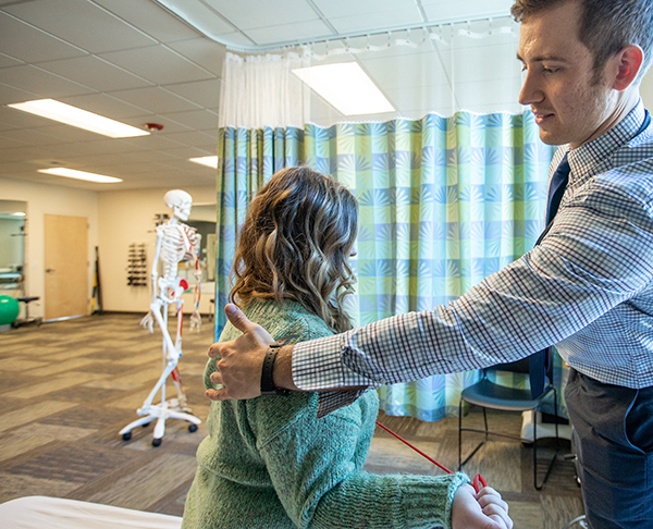 physical therapist working with patient.